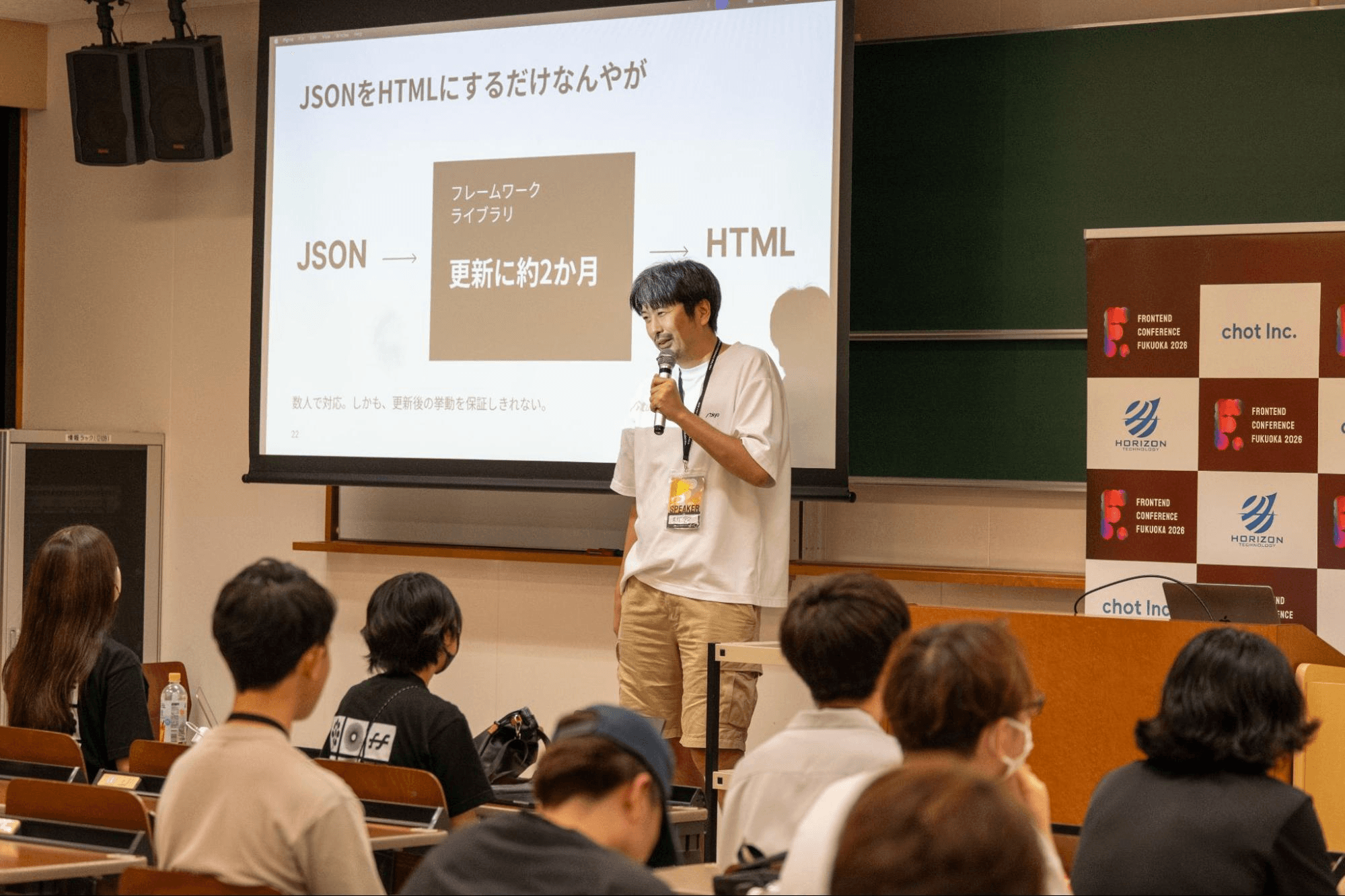 STUDIO 菅原氏のセッション。「JSONをHTMLにするだけなんやが」と題したスライドの前で話す登壇者